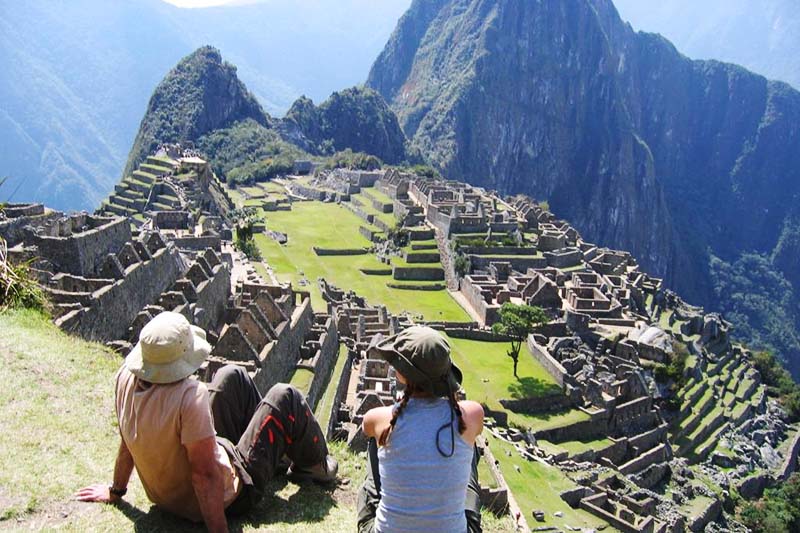 Machu Picchu Tourists appreciating the majesty of the citadel of Machu Picchu