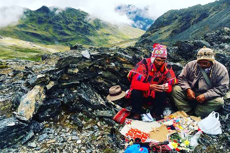 Land payment in the Mountains Shaman making a payment to the land at the foot of a mountain