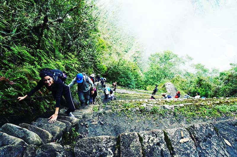 Tourists climbing the Huayna Picchu mountain