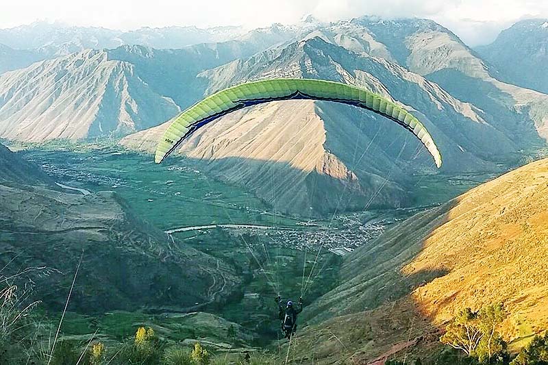 Paragliding in the Sacred Valley Tourist practicing paragliding in the Sacred Valley of the Incas