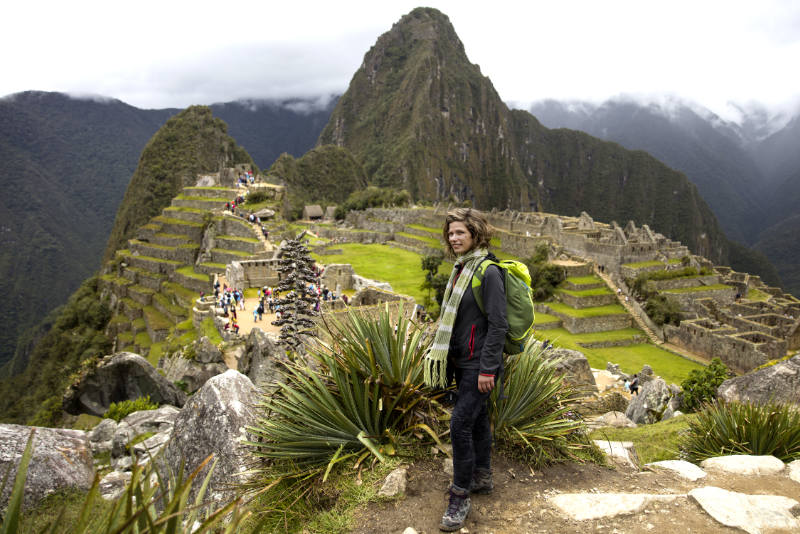 Tourist walking along the Lower Terrace of Machu Picchu
