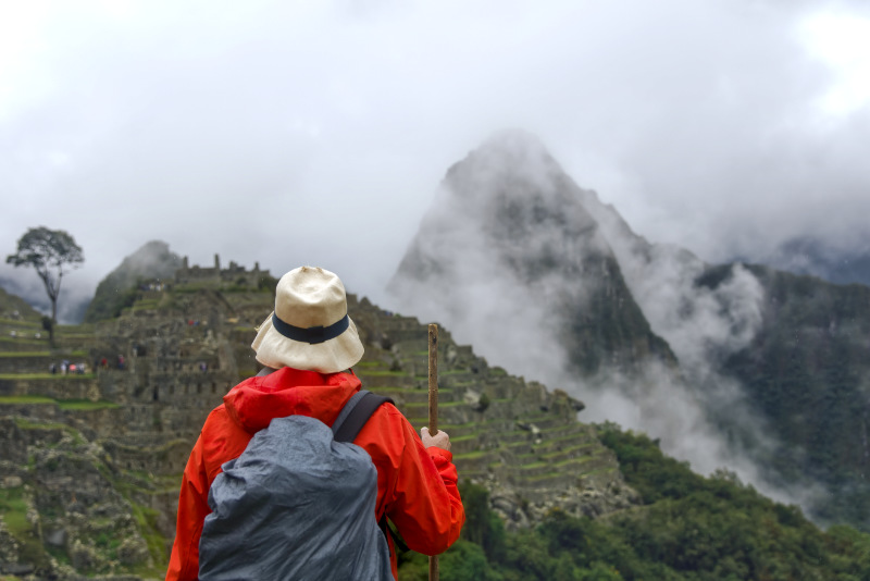 Tourist exploring the ruins at Machu Picchu