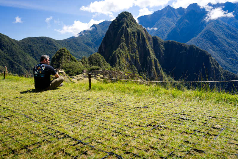 Seated tourist observing the Inca Citadel